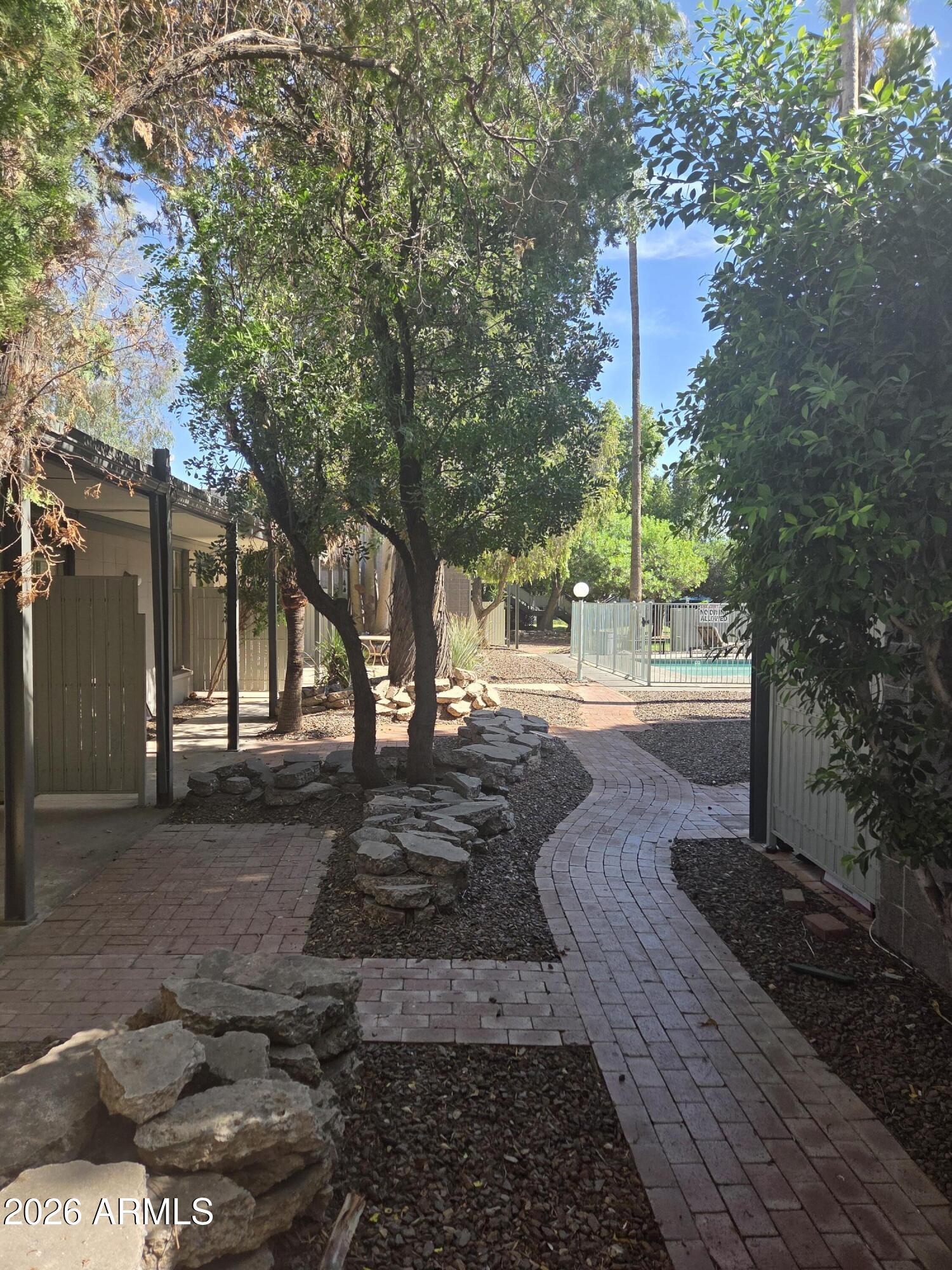 1101 East Bethany Home Road, Unit 7 Phoenix, AZ 85014 - Photo 2 of 14 a view of a yard with plants and trees