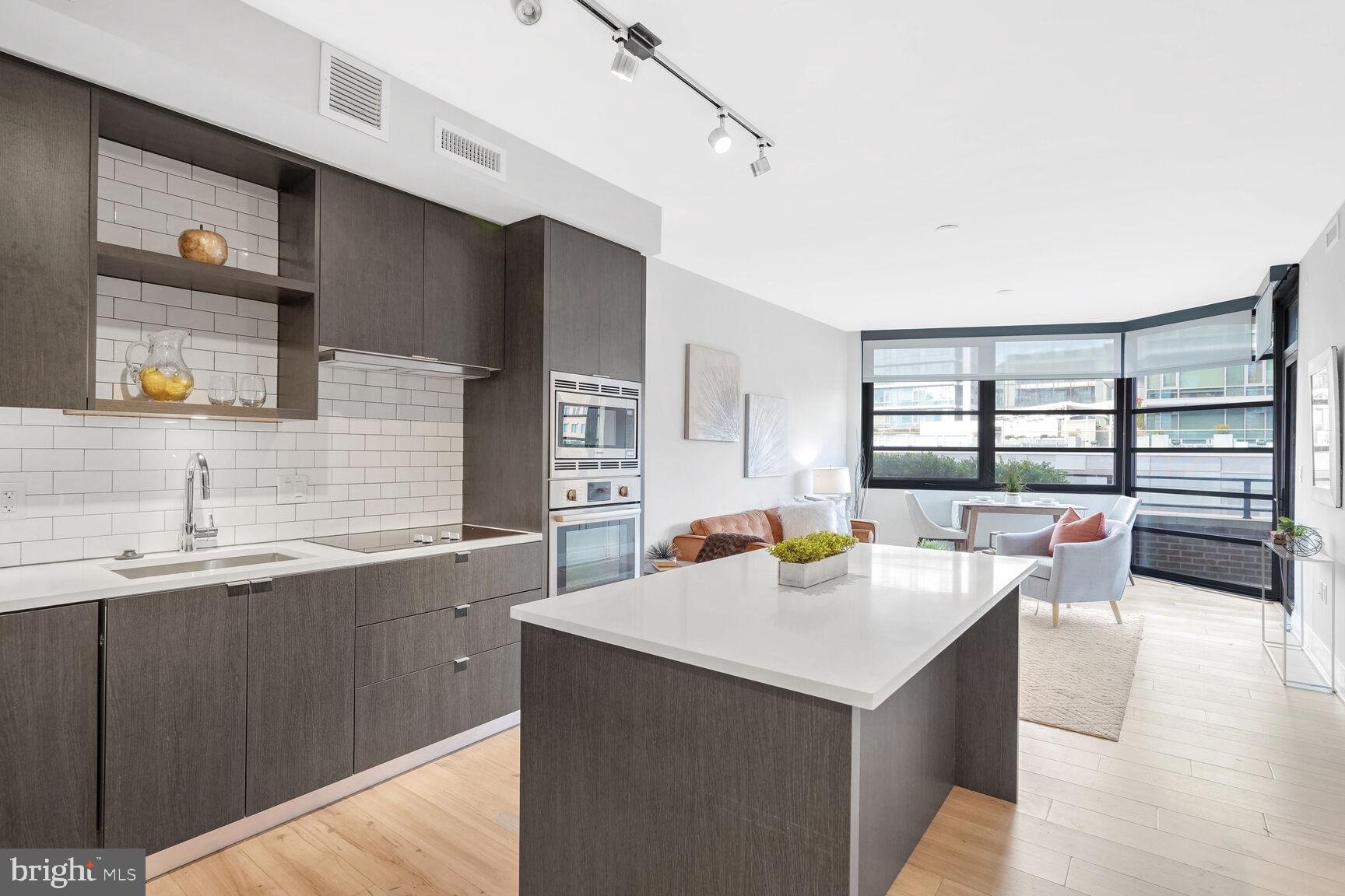 1300 4th Street Southeast, Unit 413 Washington, DC 20003 - Photo 2 of 29 a living room with stainless steel appliances kitchen island furniture and a kitchen view