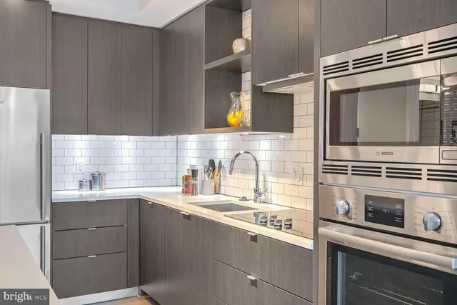 a kitchen with a sink stove and microwave