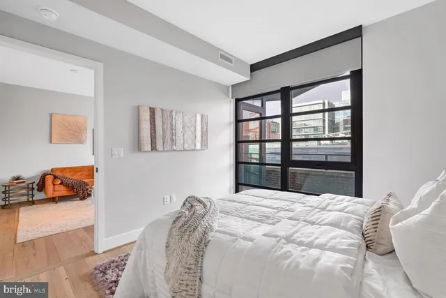 a bedroom with a bed and a window