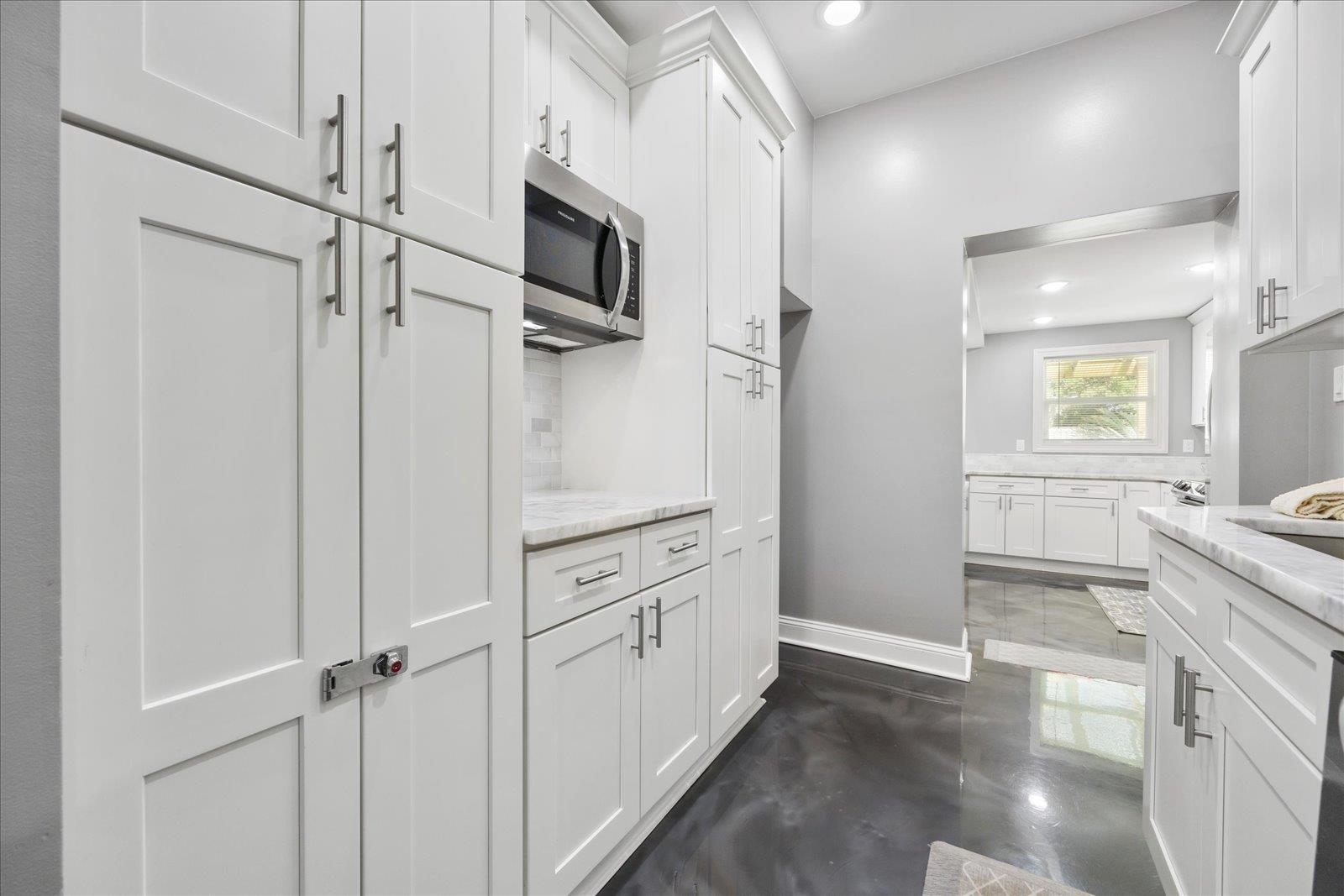 12 Dallyon Avenue St. Augustine, FL 32080 - Photo 20 of 60 a view of a kitchen with white cabinets and stainless steel appliances