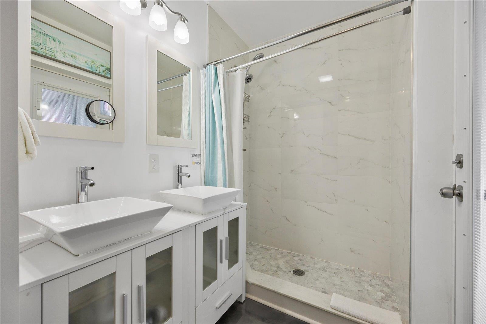 12 Dallyon Avenue St. Augustine, FL 32080 - Photo 27 of 60 a bathroom with a shower sink vanity and mirror