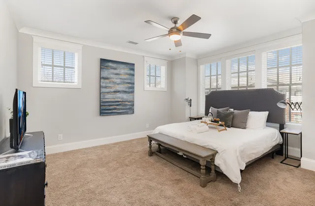a bedroom with a bed a window and dresser