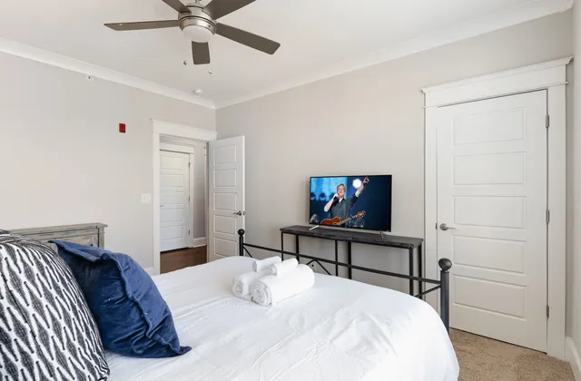 a bedroom with a bed and a flat screen tv