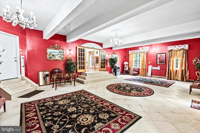 a view of living room with furniture and a chandelier