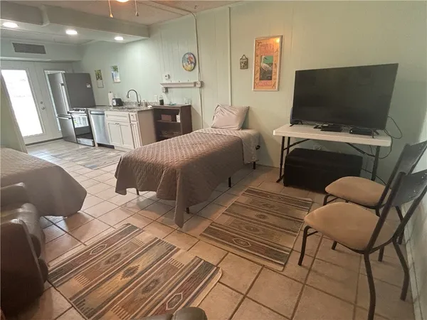 a bedroom with furniture and a flat screen tv