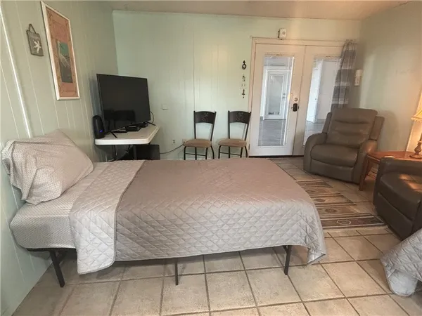 a bedroom with a bed and a television