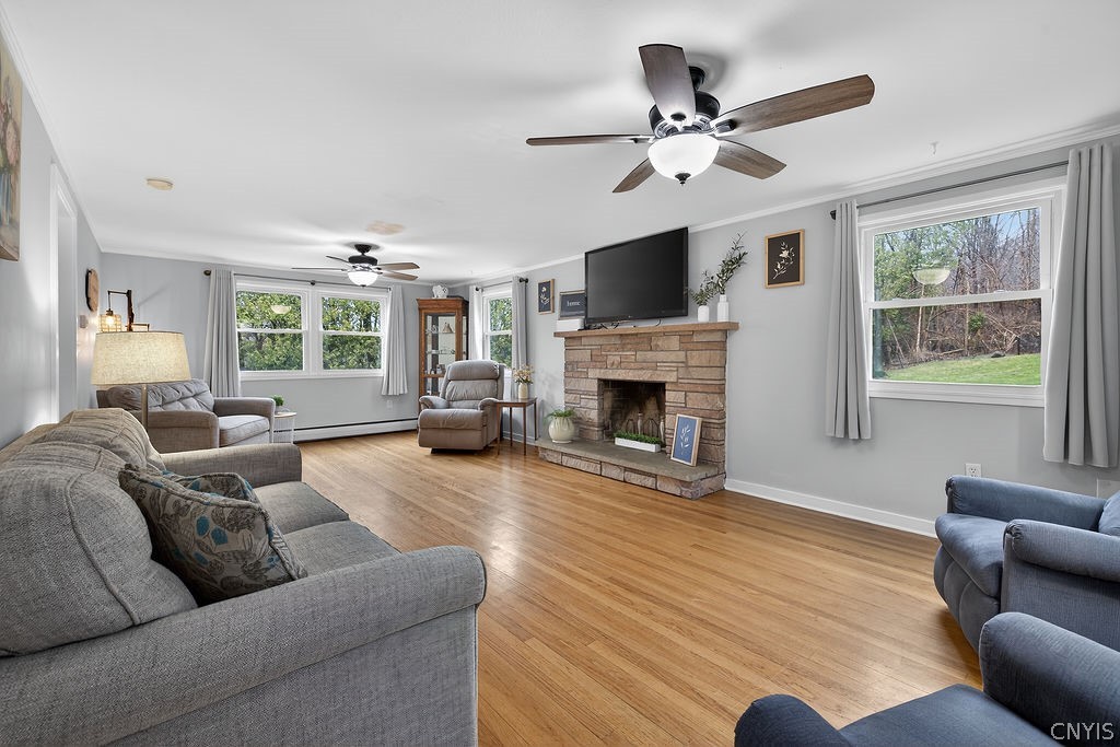 2541 Lyons Road Camillus, NY 13031 - Photo 4 of 41 Family room has hardwood floors, wood burning fire