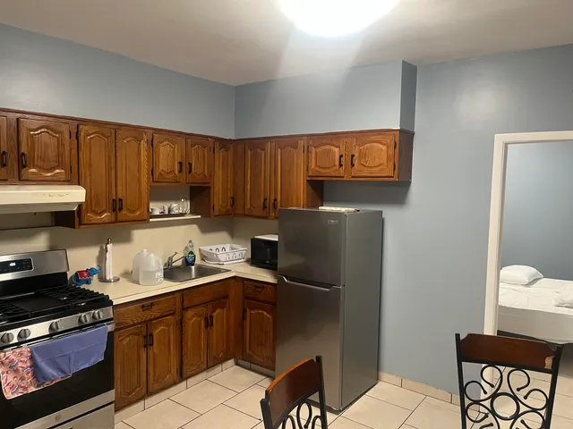 a kitchen with a refrigerator and a stove top oven