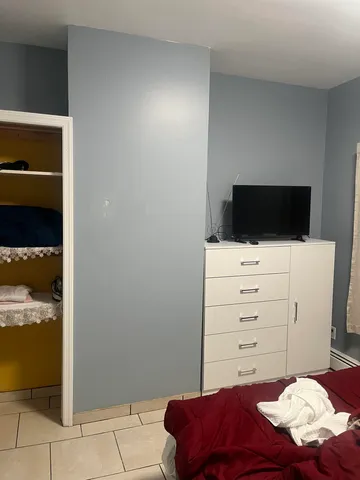 a room with a bed and a television