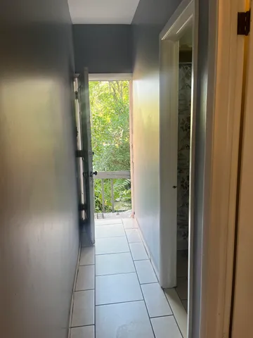 a front view of a house with a wooden deck