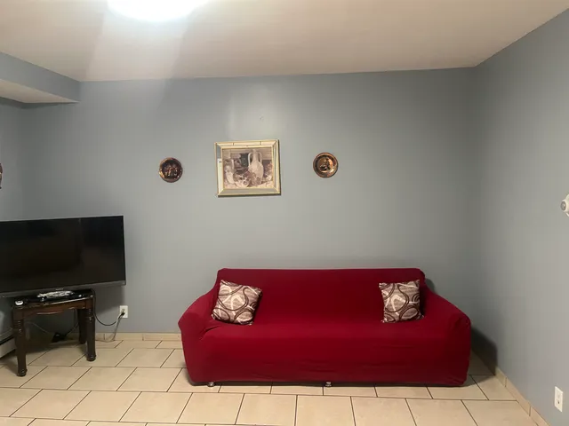 a view of a living room with furniture and a flat screen tv