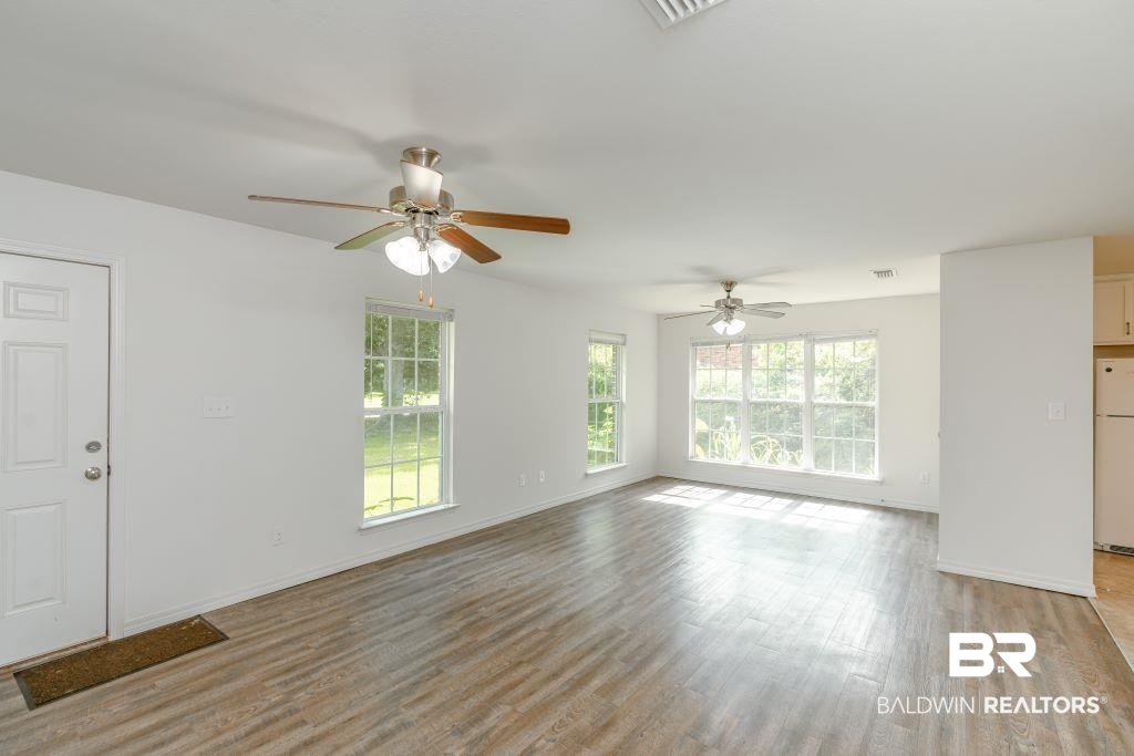 12641 Pecan Street Grand Bay, AL 36541 - Photo 6 of 23 Unfurnished living room featuring light hardwood / wood-style floors and ceiling fan