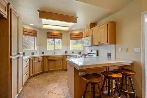 a kitchen with a sink stove top oven and cabinets