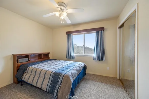 a bathroom with a toilet a sink and a mirror