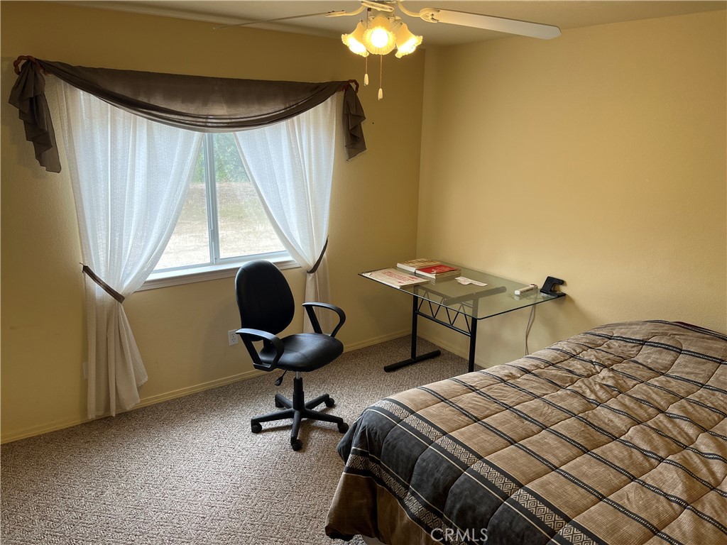 3151 Parkhill Road Santa Margarita, CA 93453 - Photo 21 of 49 a bedroom with a bed and a chandelier