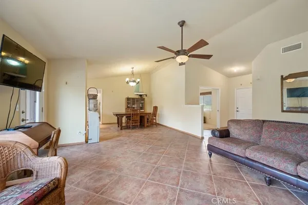a view of a dining room with furniture and chandelier