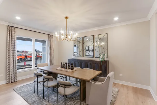 a view of a dining room with furniture wooden floor and chandelier