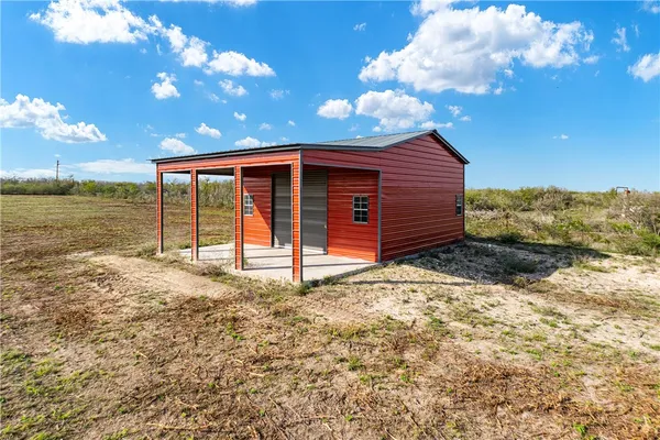 a view of a backyard with large tree