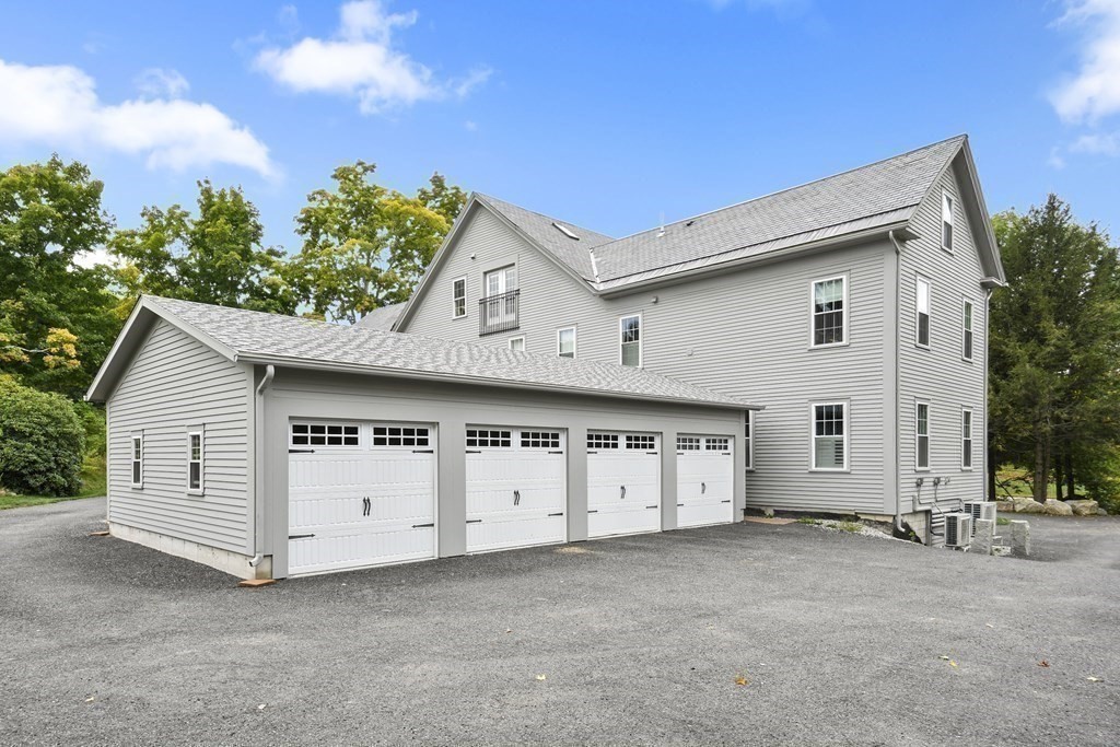 166 Littleton Road, Unit 4 Harvard, MA 01451 - Photo 3 of 31 a view of a house with garage