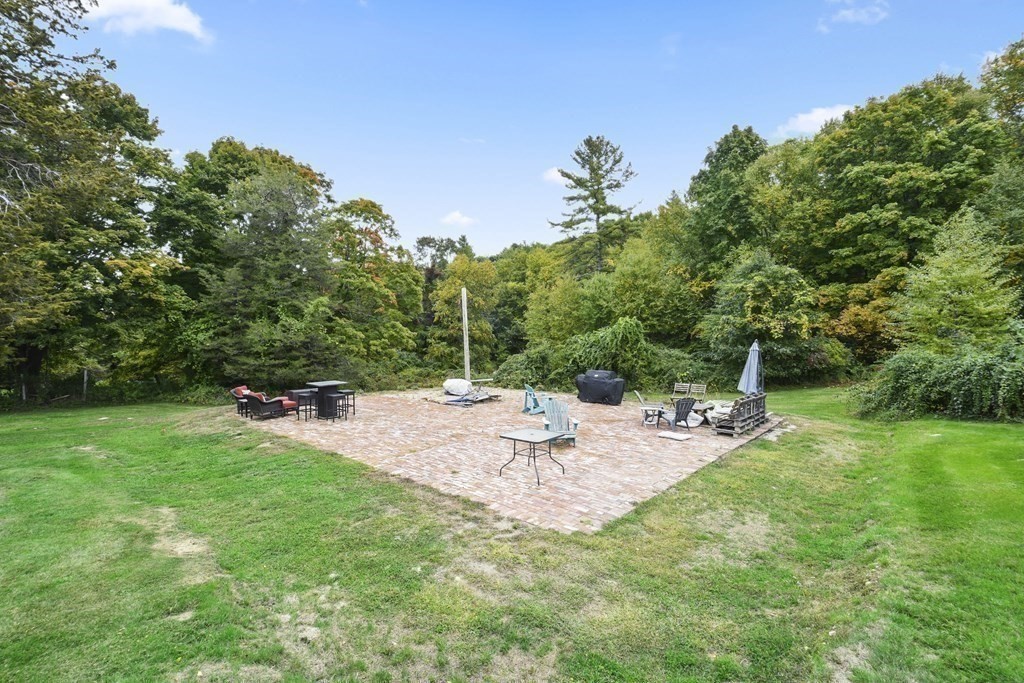 166 Littleton Road, Unit 4 Harvard, MA 01451 - Photo 4 of 31 a view of a backyard with sitting area