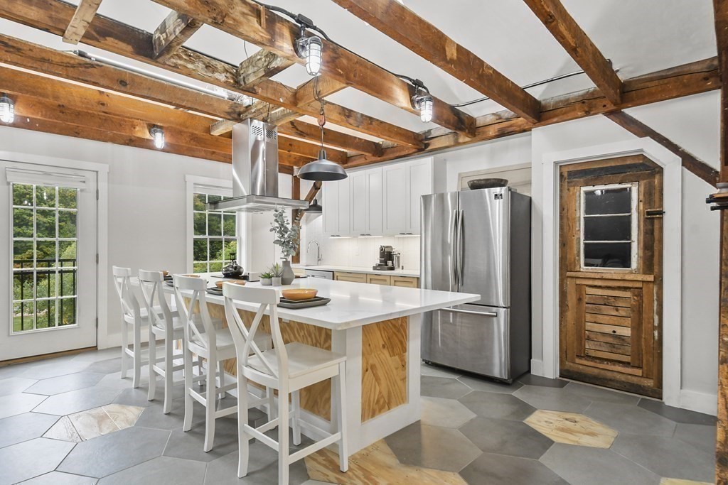 166 Littleton Road, Unit 4 Harvard, MA 01451 - Photo 7 of 31 a view of a kitchen with refrigerator and windows