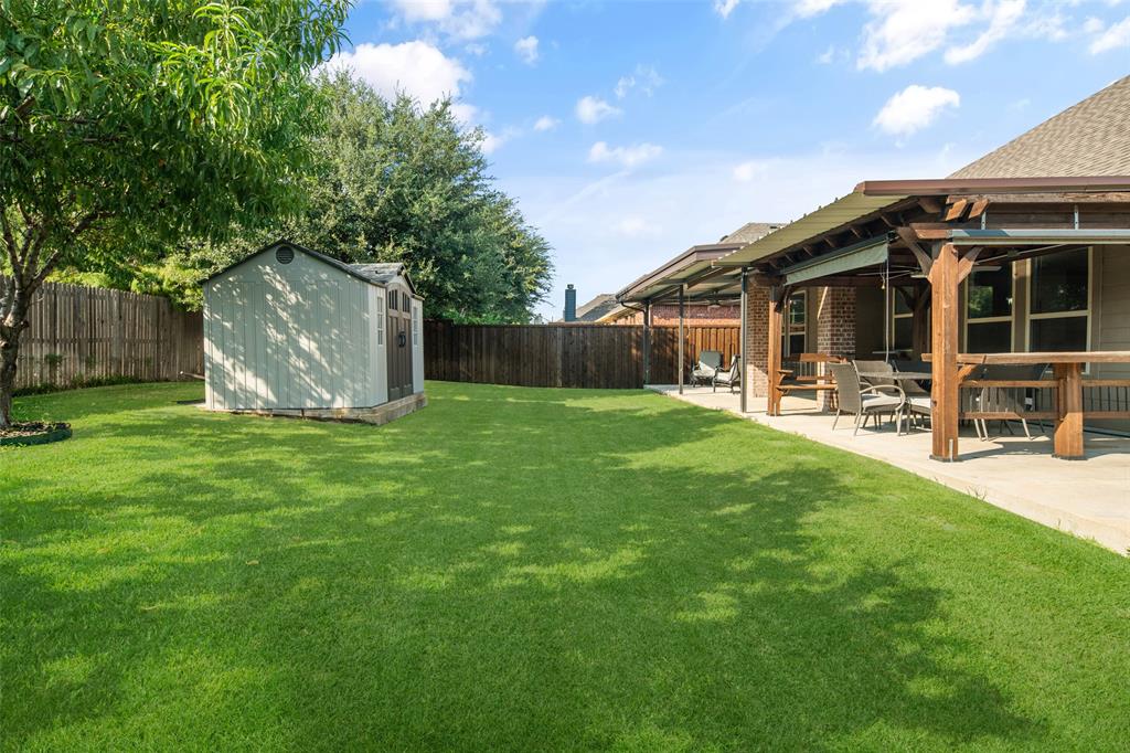 a view of a house with a yard and sitting area