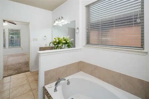 a bathroom with a bathtub and shower