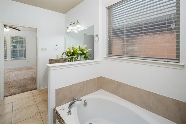 a bathroom with a bathtub and shower