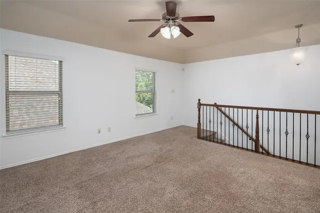 a view of a livingroom with a ceiling fan and window