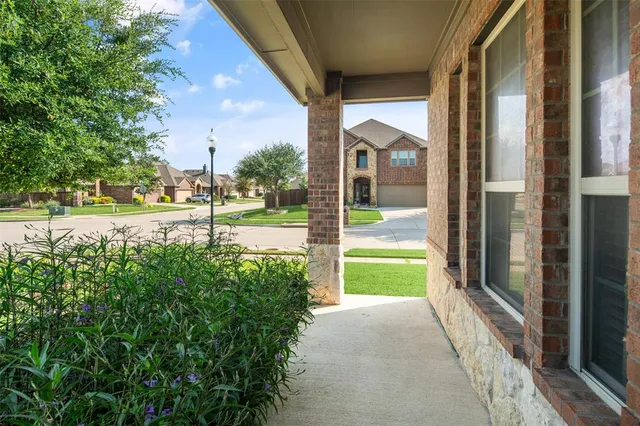 a view of a house with a yard and porch