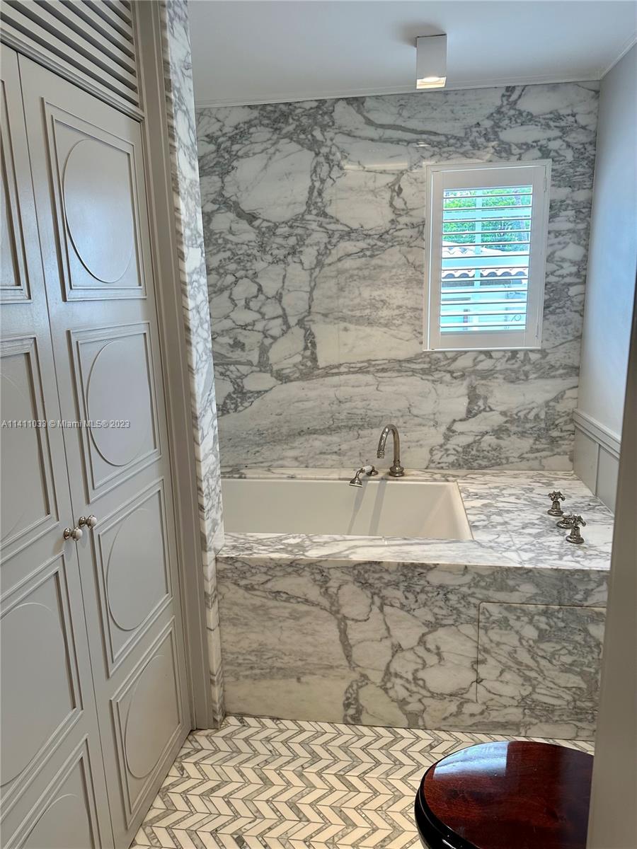 Mid Beach Miami Beach, FL 33140 - Photo 11 of 40 a bathroom with a granite countertop sink a mirror and shower