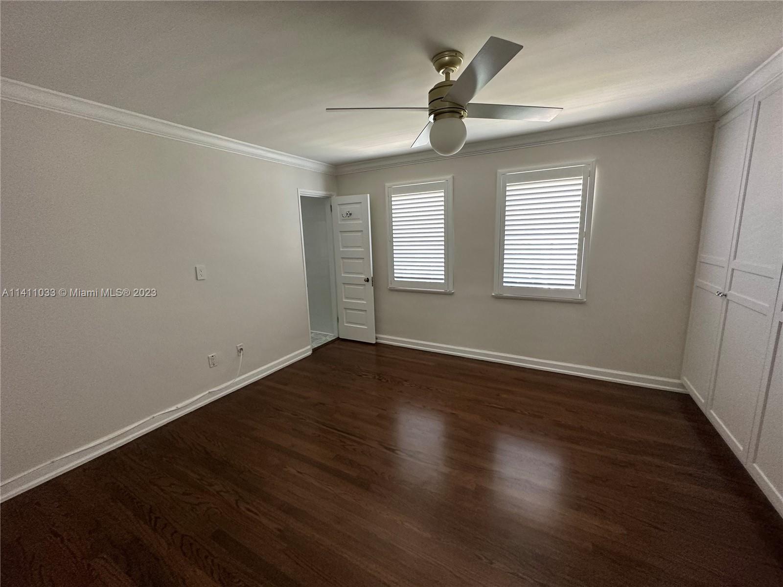Mid Beach Miami Beach, FL 33140 - Photo 13 of 40 an empty room with wooden floor fan and windows