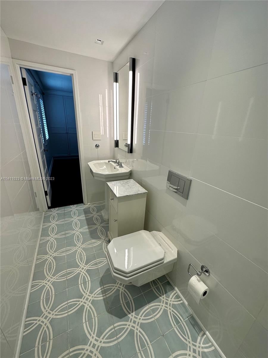 Mid Beach Miami Beach, FL 33140 - Photo 16 of 40 a bathroom with a toilet and a shower