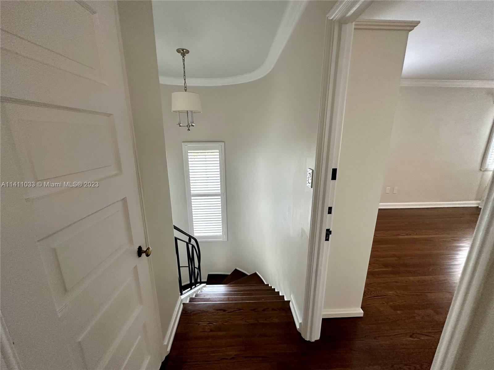 Mid Beach Miami Beach, FL 33140 - Photo 17 of 40 a view of a hallway with wooden floor and stairs