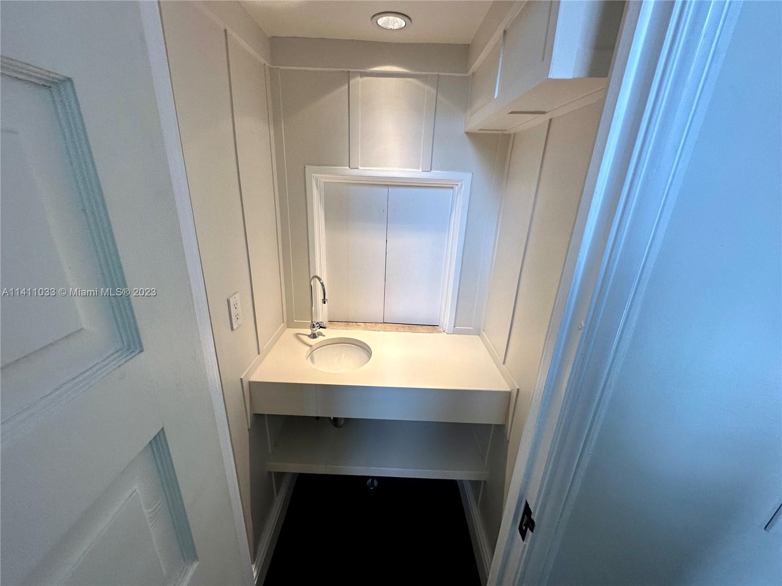 Mid Beach Miami Beach, FL 33140 - Photo 20 of 40 a bathroom with a sink and a mirror