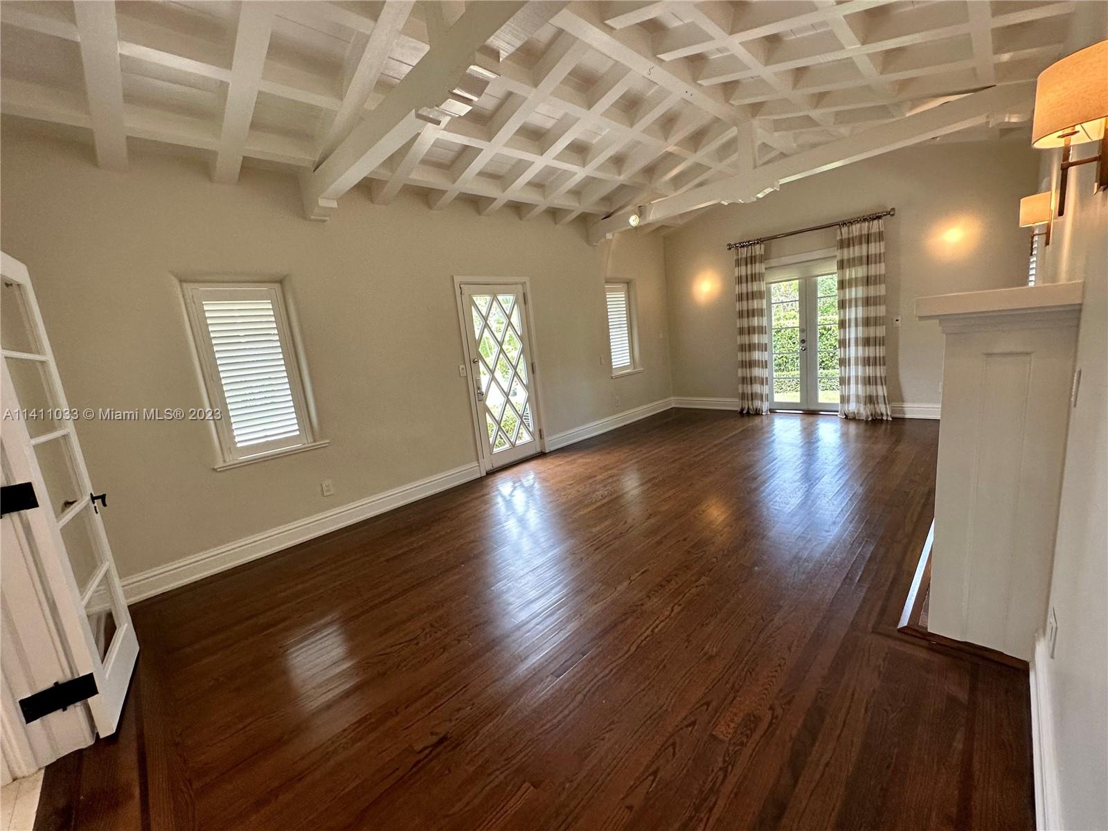 Mid Beach Miami Beach, FL 33140 - Photo 22 of 40 a view of an empty room with wooden floor and a window