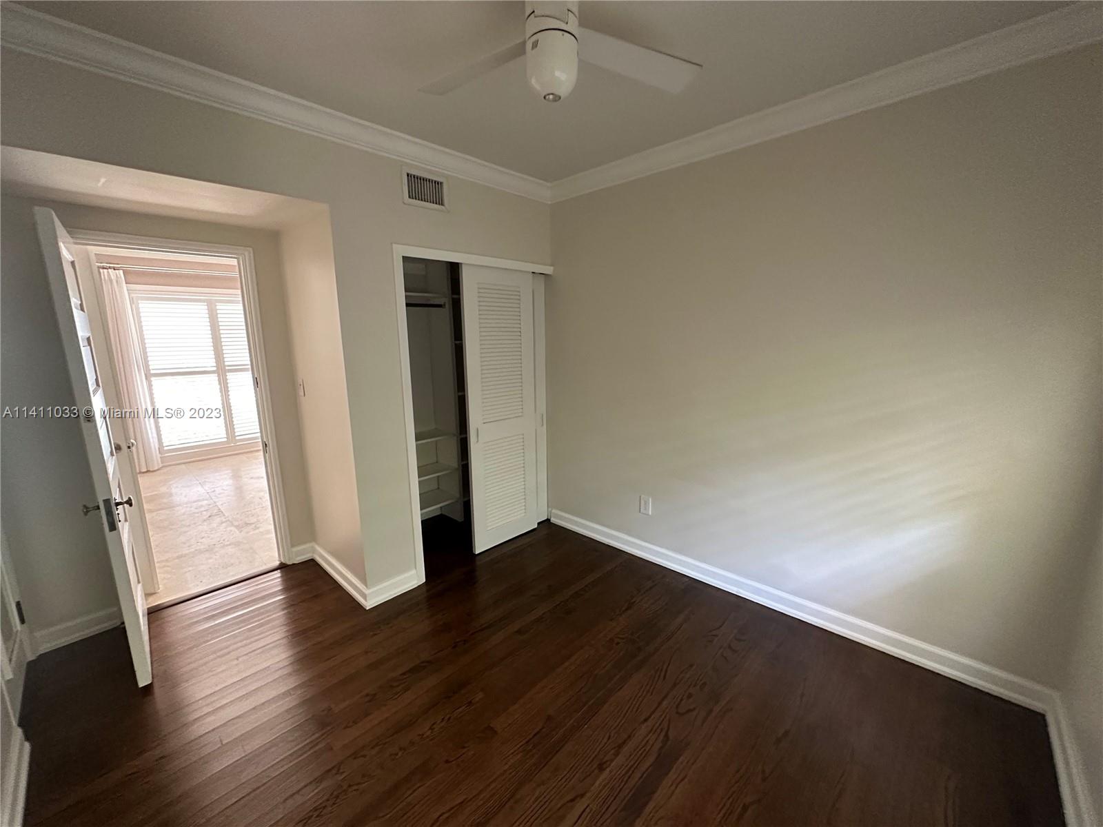 Mid Beach Miami Beach, FL 33140 - Photo 29 of 40 an empty room with wooden floor and windows