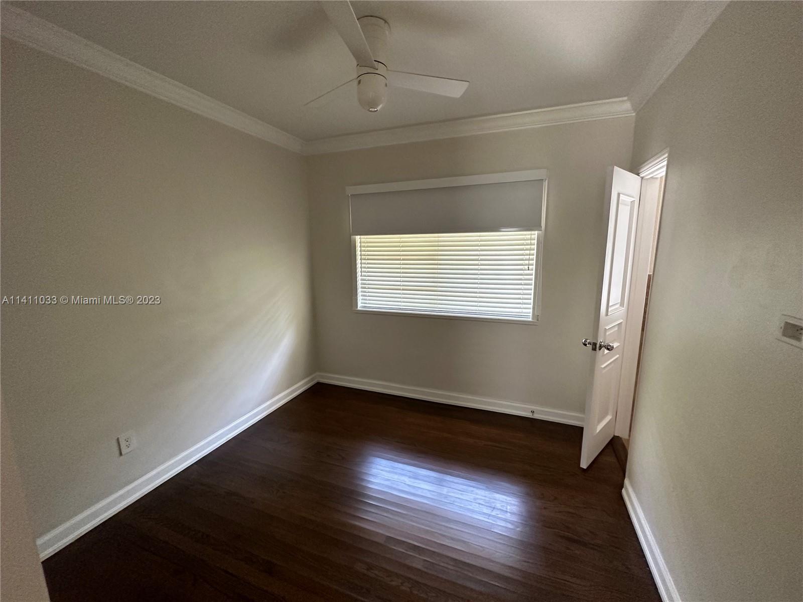 Mid Beach Miami Beach, FL 33140 - Photo 30 of 40 an empty room with wooden floor and windows