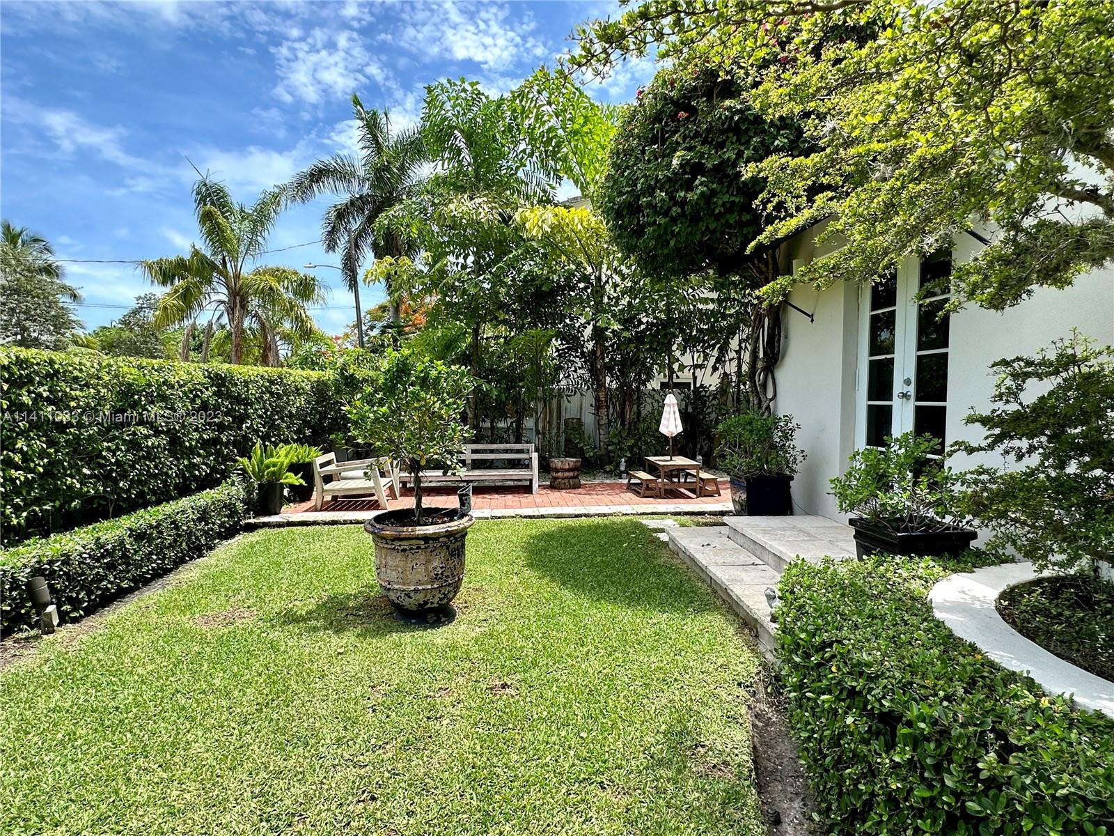 Mid Beach Miami Beach, FL 33140 - Photo 3 of 40 a view of a backyard with sitting area and fire pit