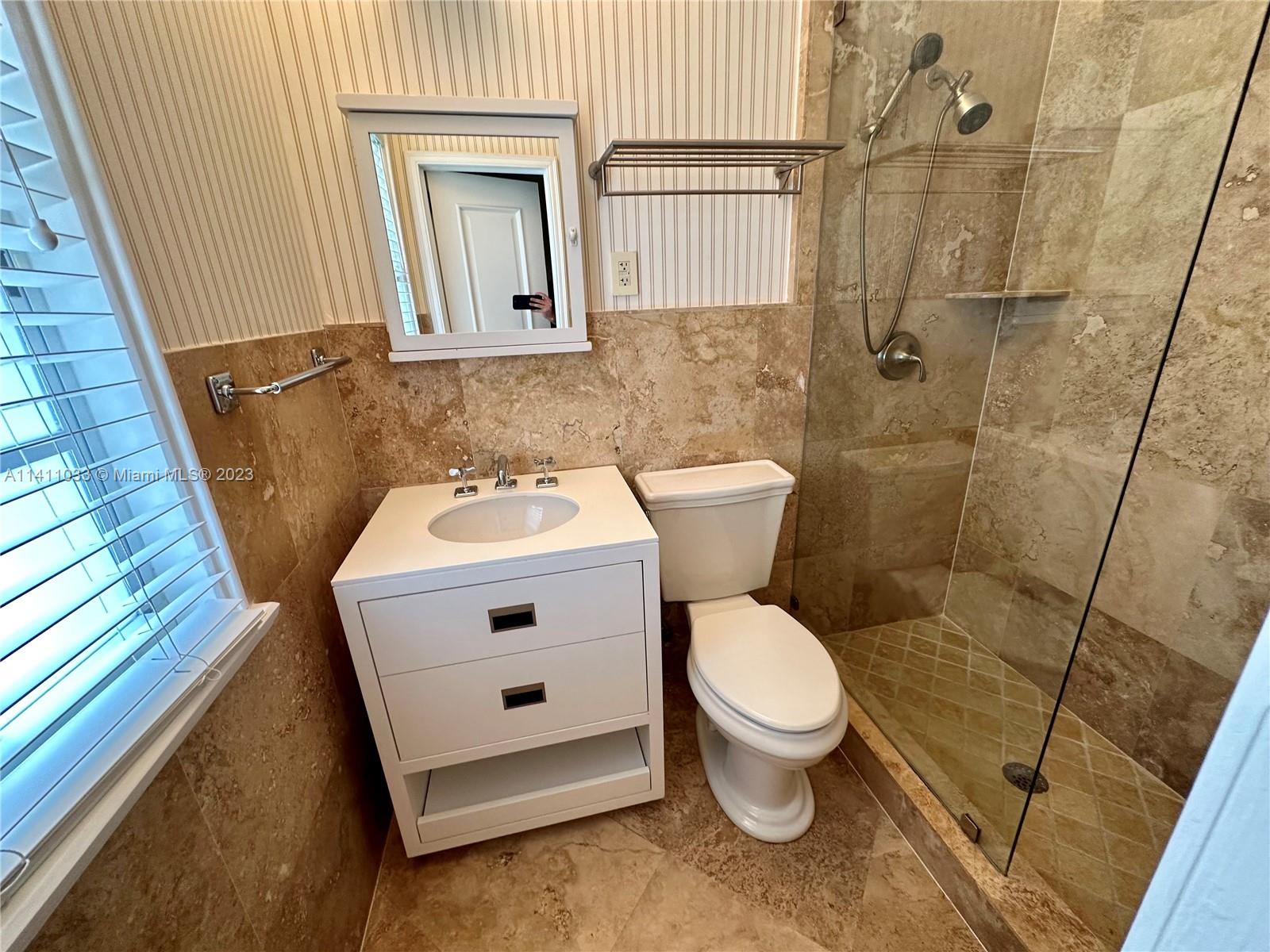 Mid Beach Miami Beach, FL 33140 - Photo 31 of 40 a bathroom with a sink a toilet and shower