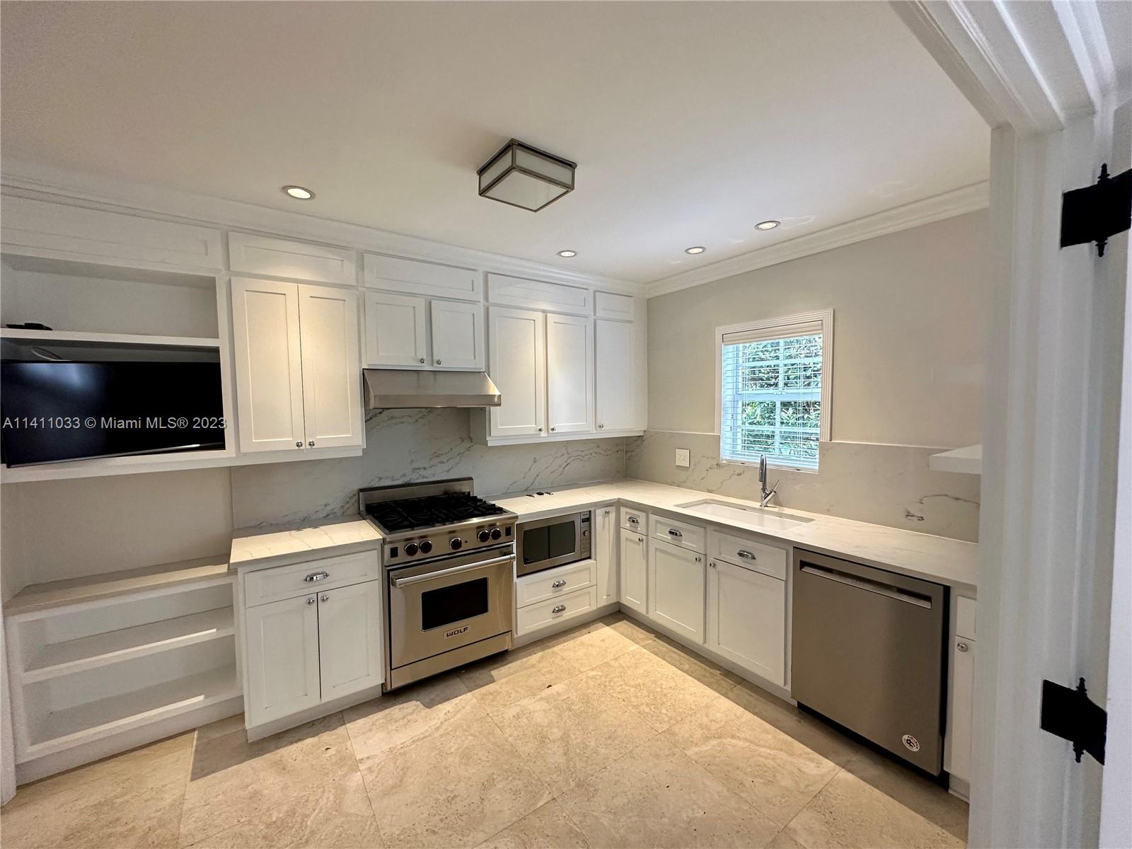 Mid Beach Miami Beach, FL 33140 - Photo 33 of 40 a kitchen with a stove sink and microwave
