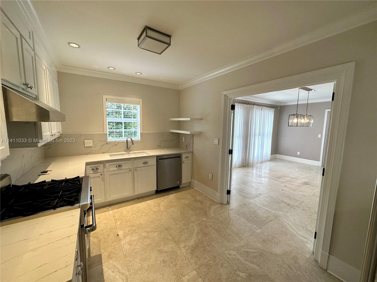 Mid Beach Miami Beach, FL 33140 - Photo 34 of 40 a view of a kitchen with a sink and a refrigerator