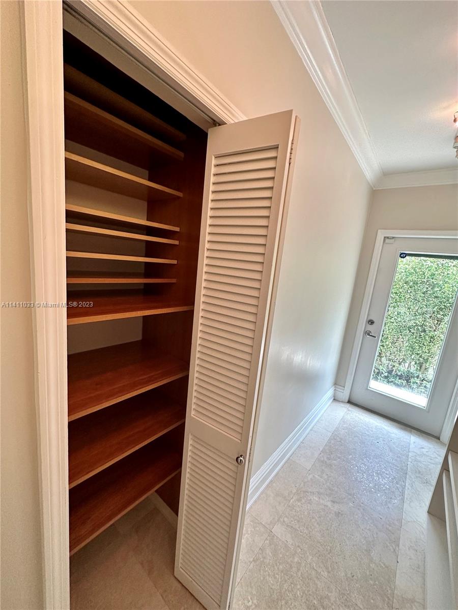 Mid Beach Miami Beach, FL 33140 - Photo 37 of 40 a view of walk in closet with empty racks