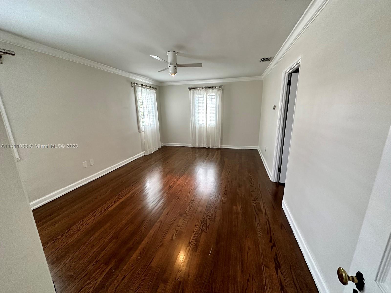 Mid Beach Miami Beach, FL 33140 - Photo 7 of 40 an empty room with wooden floor and windows
