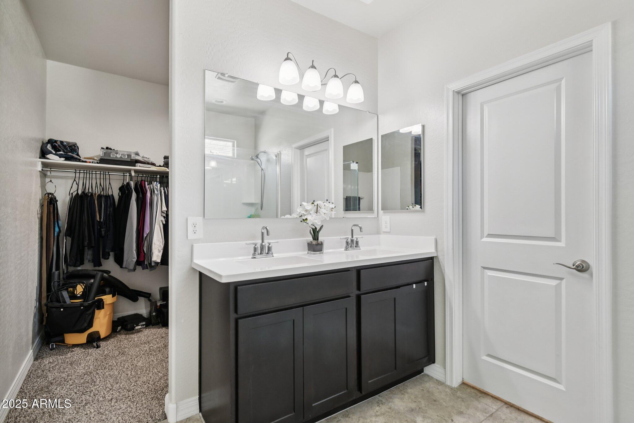 18819 West Farmer Road Buckeye, AZ 85326 - Photo 11 of 23 a bathroom with a sink vanity and a mirror