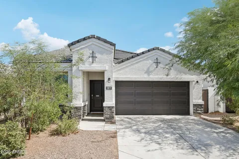a front view of a house with a yard and garage