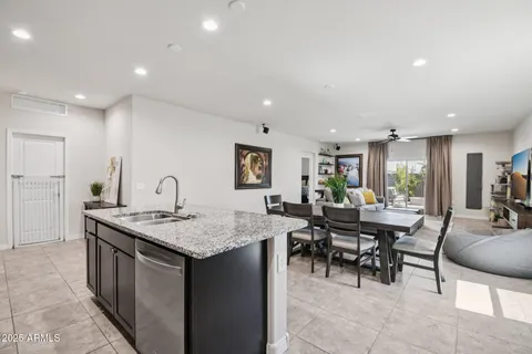 a large kitchen with granite countertop lots of counter space and stainless steel appliances