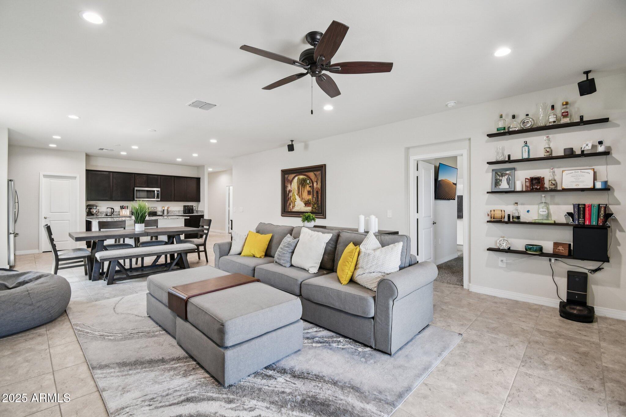 18819 West Farmer Road Buckeye, AZ 85326 - Photo 6 of 23 a living room with furniture kitchen view and a chandelier