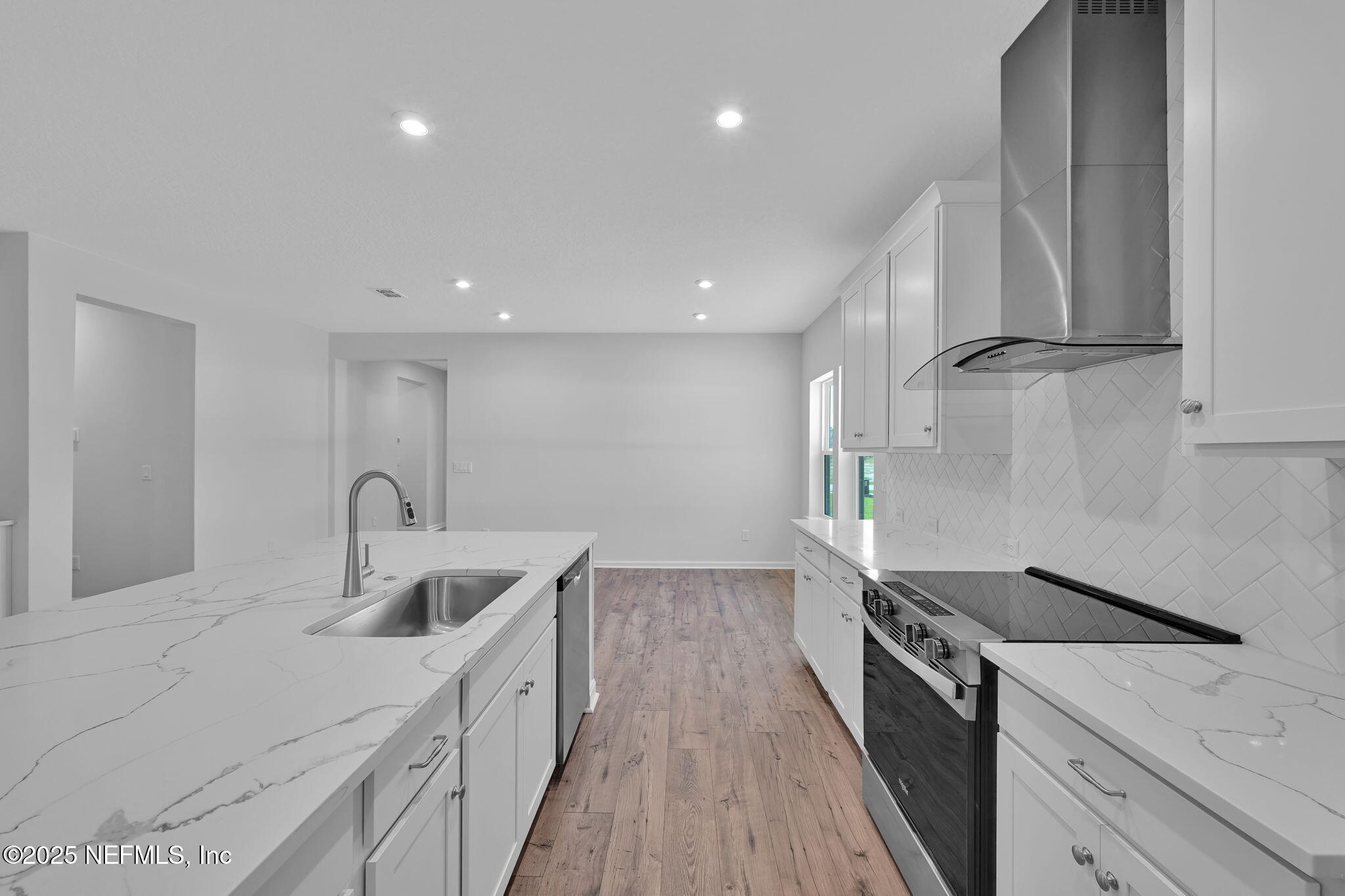 97003 Mcgirts Creek Loop Yulee, FL 32097 - Photo 11 of 40 a kitchen with granite countertop a sink and a stove top oven
